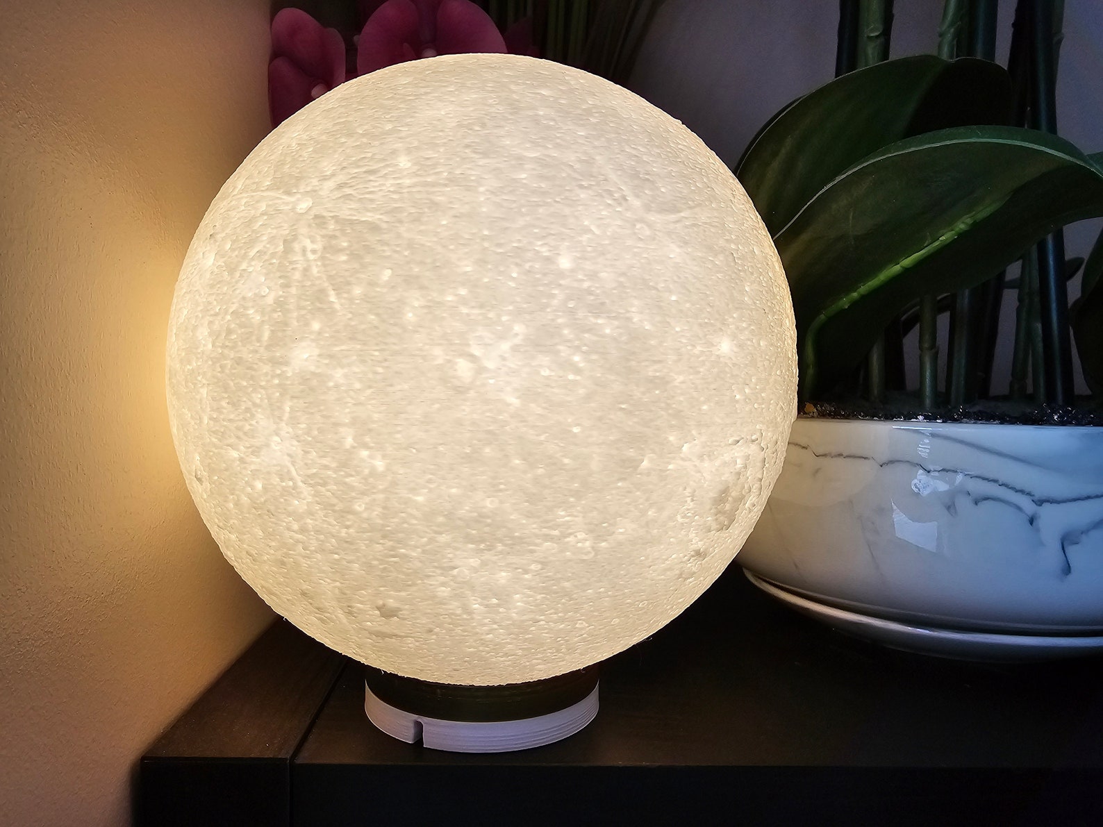 3D printed moon LED table lamp on a bedside table